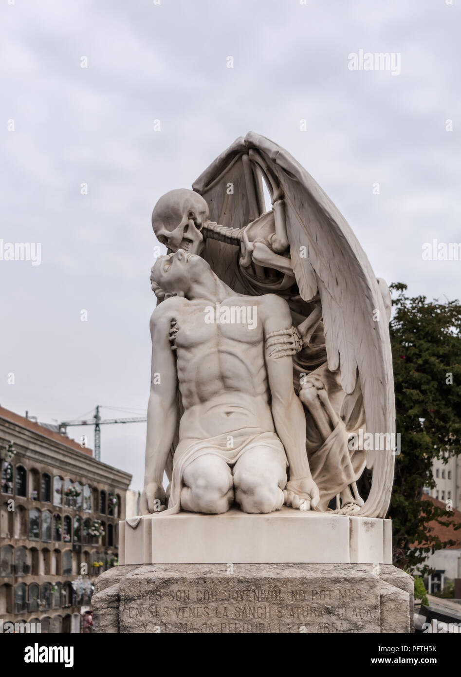 The Kiss of Death statue in Poblenou Cemetery in Barcelona. This marble sculpture depicts death, as a winged skeleton, kissing a handsome young man. T Stock Photo