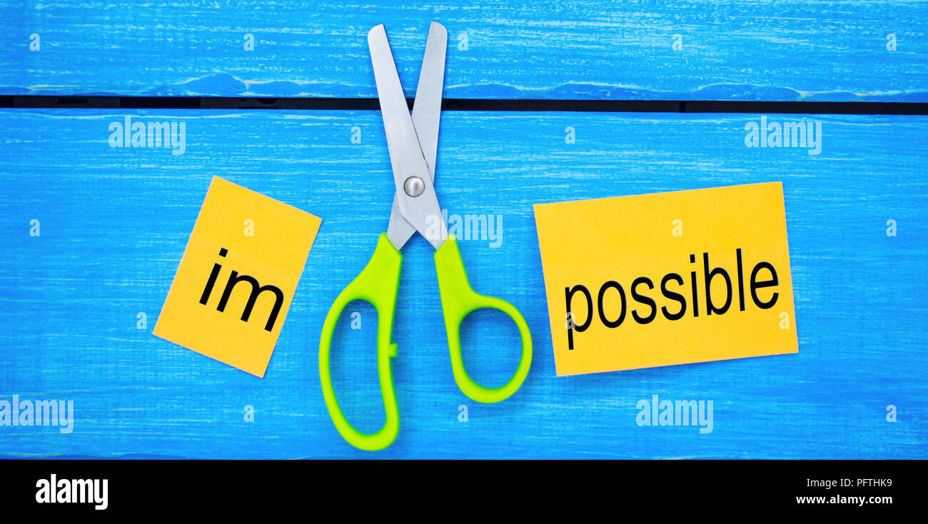 Impossible Is Possible Concept. card with the text impossible, scissors ...