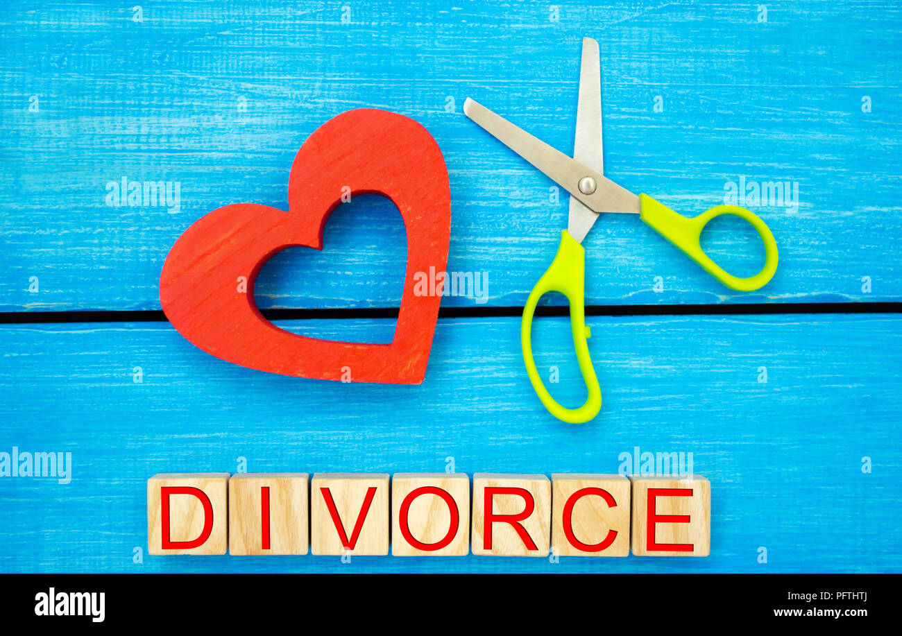 scissors cut heart. the inscription 'divorce'. the concept of breaking relations, quarrels. treachery, betrayal. cancellation of marriage. relationshi Stock Photo