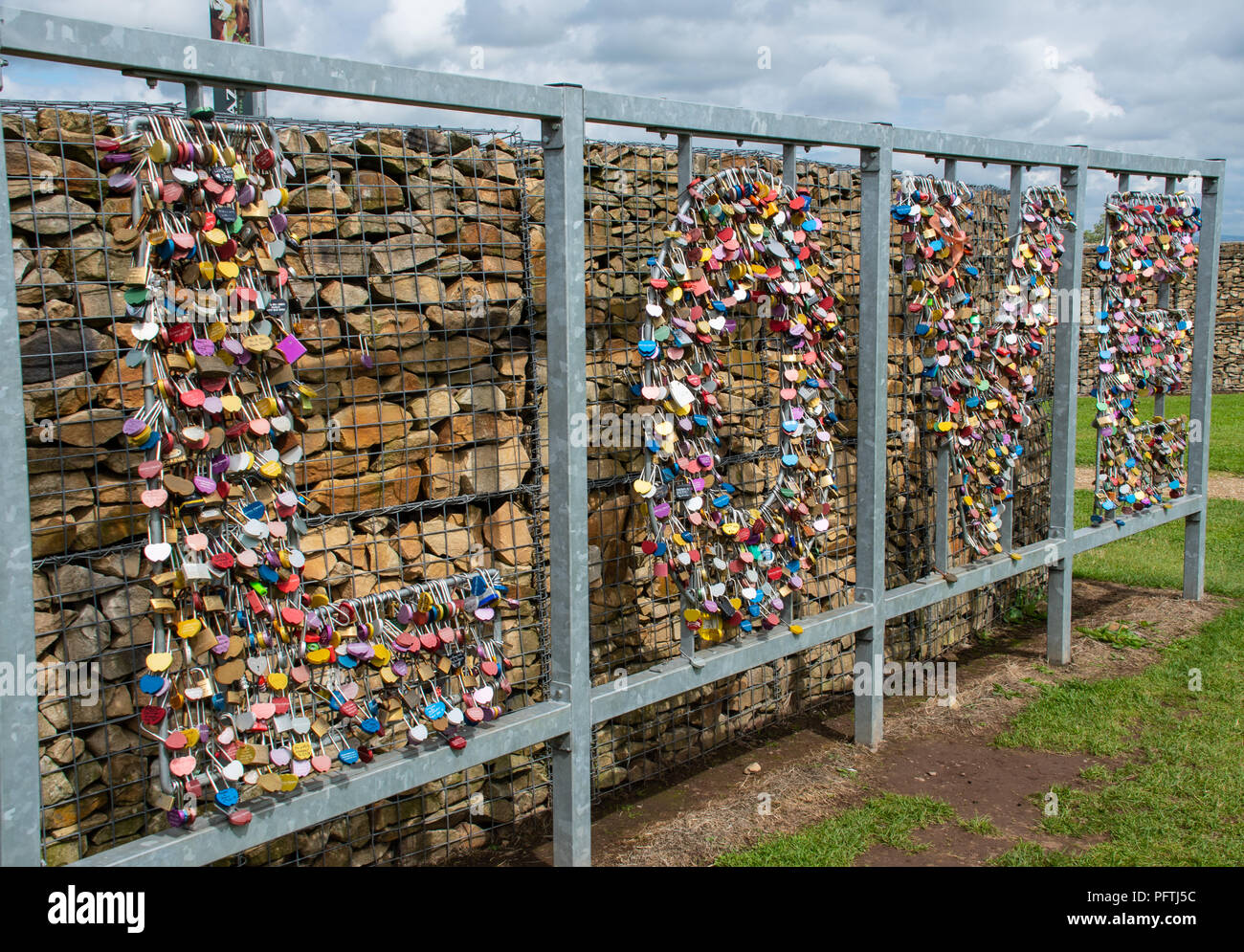 Gretna Green, United Kingdom - August 08 2018:   A collection of love locks - padlocks with personal messages on them, shaped into the word LOVE near  Stock Photo