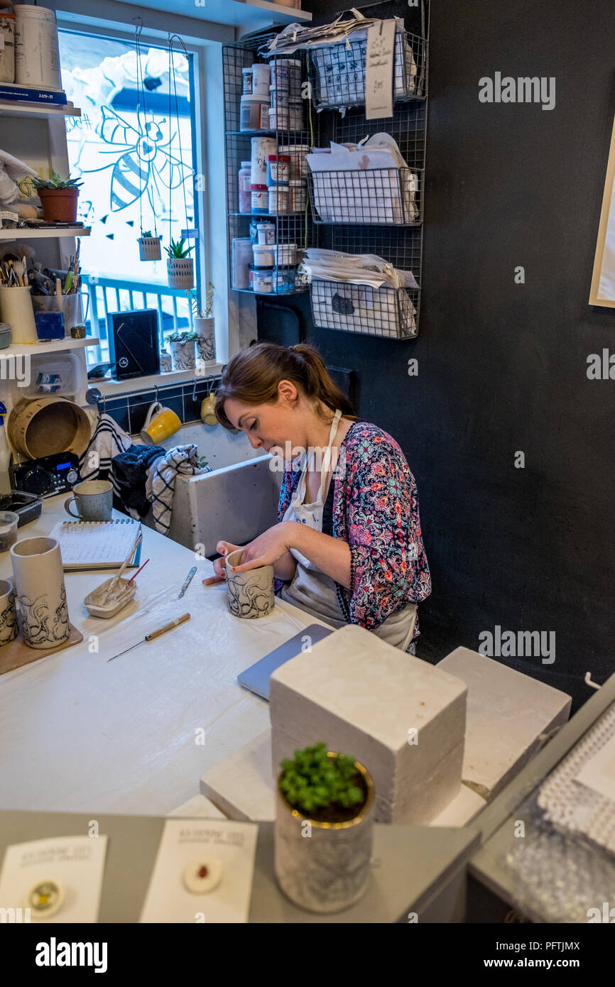 A young lady working in her workshop making ceramic jugs Stock Photo