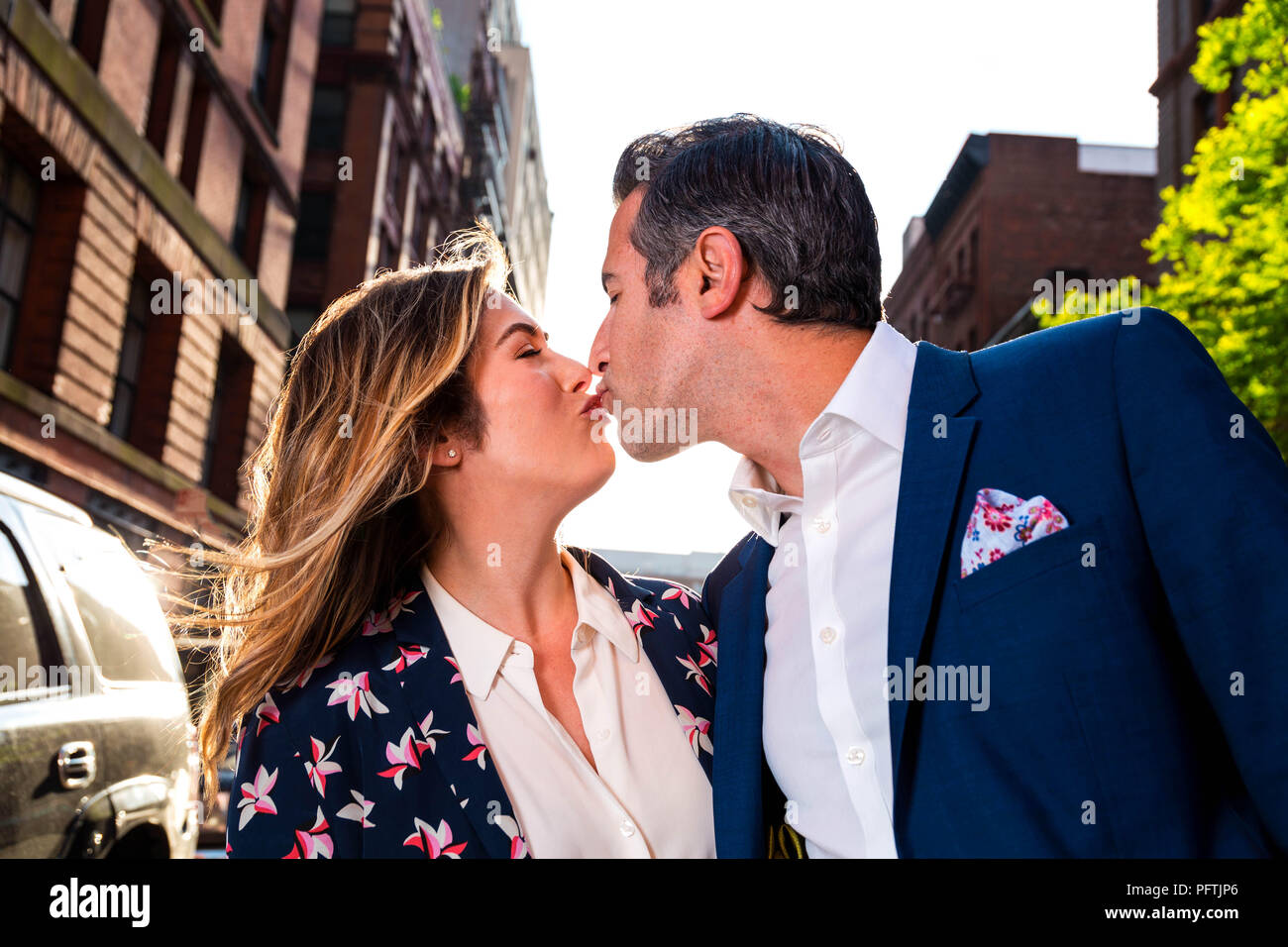 Caucasian New York City Man and Woman Couple Act Silly and Lovingly On The Streets Of Manhattan Stock Photo
