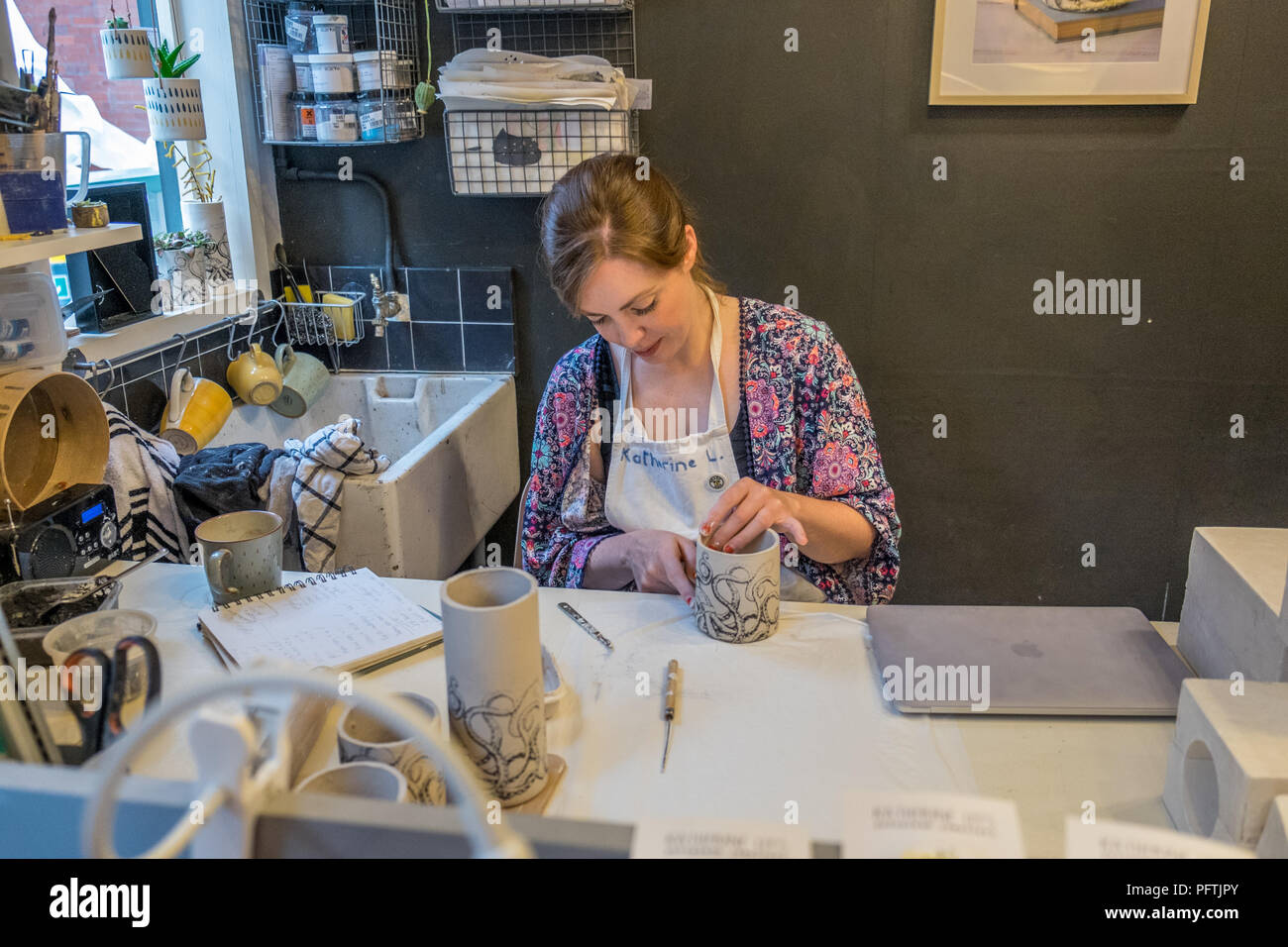 A young lady working in her workshop making ceramic jugs Stock Photo