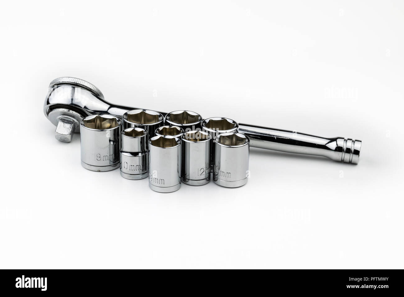 A shiny, silver, chrome socket wrench set with metric sockets in various sizes in millimeters on a white background like an automobile mechanic, repai Stock Photo