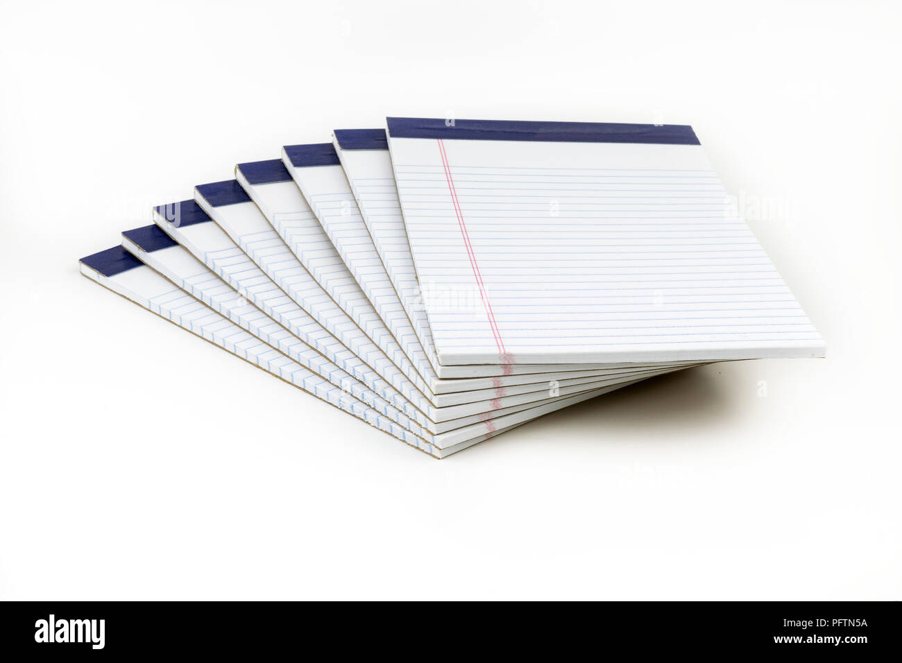 A neatly stacked pile of whte, ruled notebpads with blue binding.. These could be used as school or office supplies for taking notes and sharing ideas Stock Photo