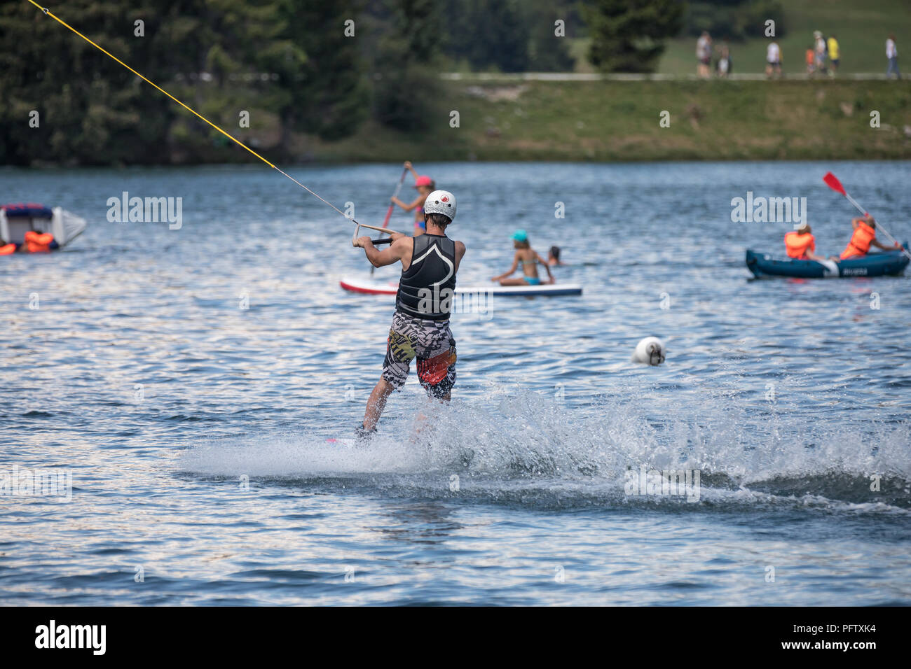 wake boarding with a cable on the lake Stock Photo