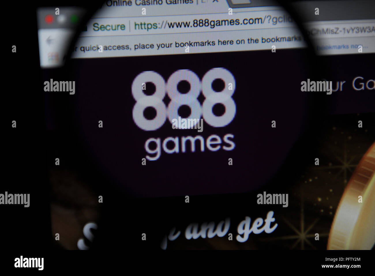 The 888 games website seen through a magnifying glass Stock Photo