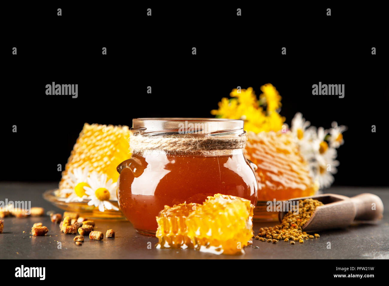Honey jar and dipper with leaking honey Stock Photo Alamy