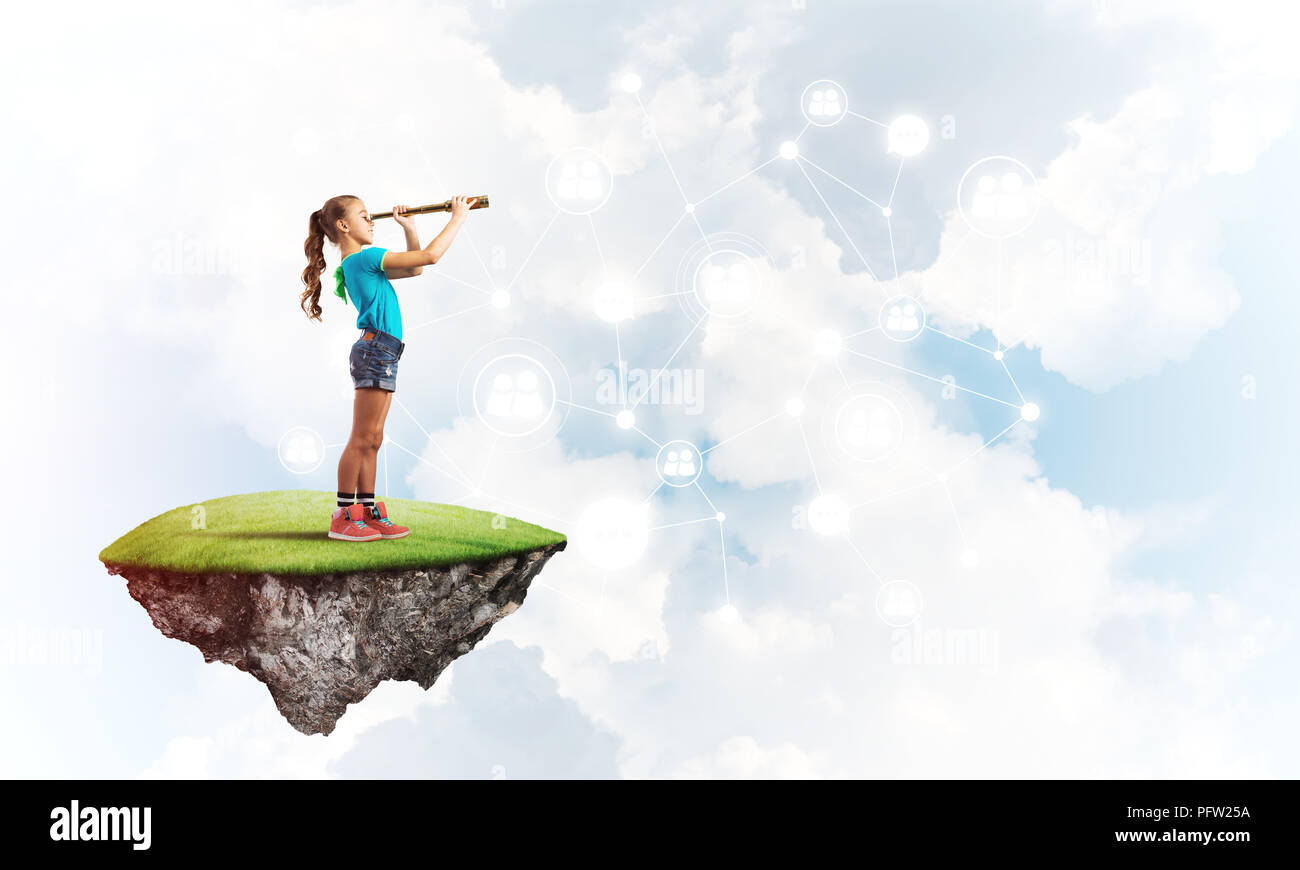 Concept of careless happy childhood with girl looking in spyglass Stock ...