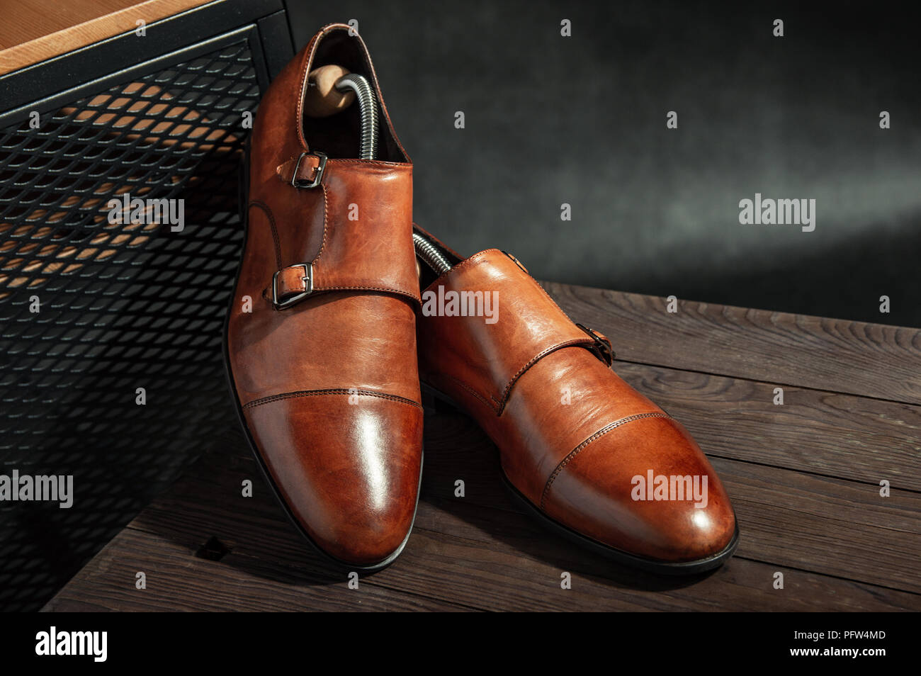 Elegant brown monk shoes with double strap on a wooden table Stock Photo