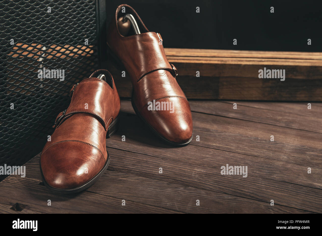 Double strap monk shoes on wooden table with copy space for your text Stock Photo