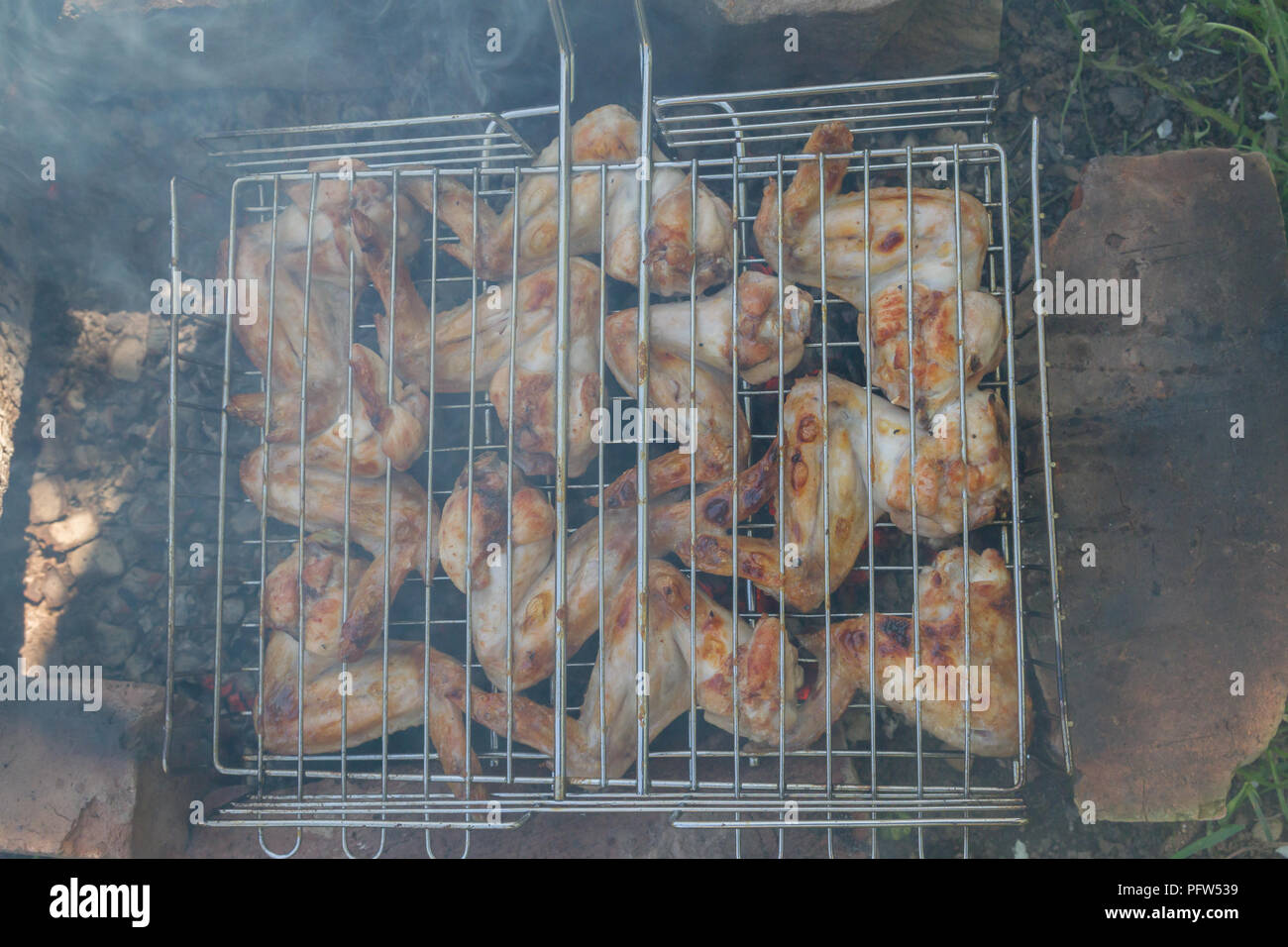 Chicken wings are cooked on charcoal on the grill Stock Photo Alamy