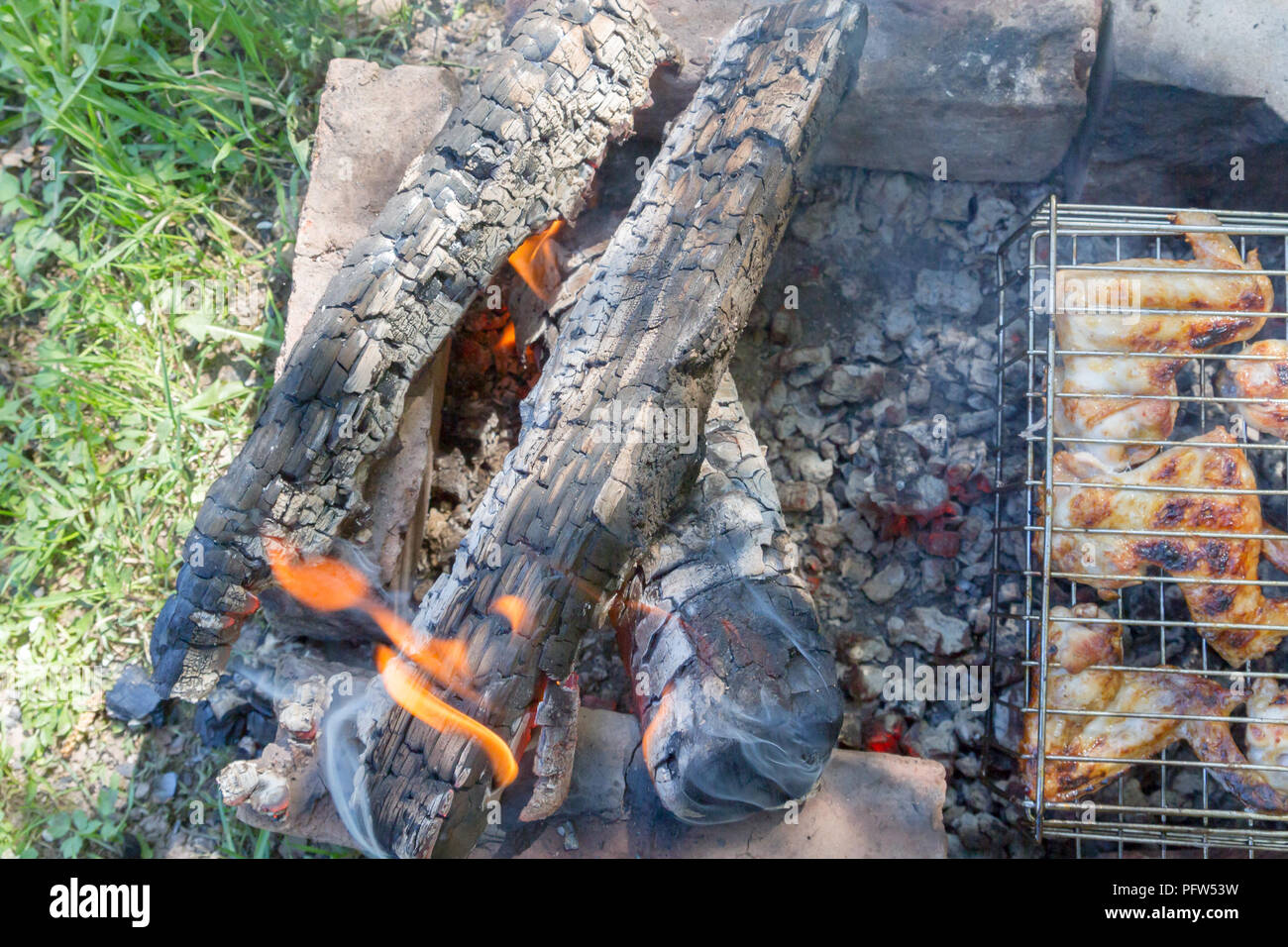 Chicken wings are cooked on charcoal on the grill Stock Photo Alamy