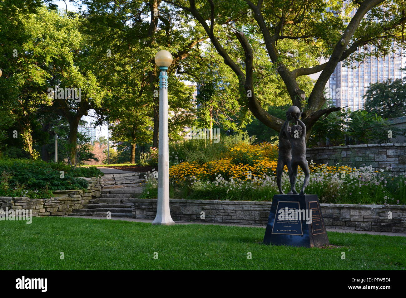 A sculpture of two children playing in Chicago's Peace Garden located