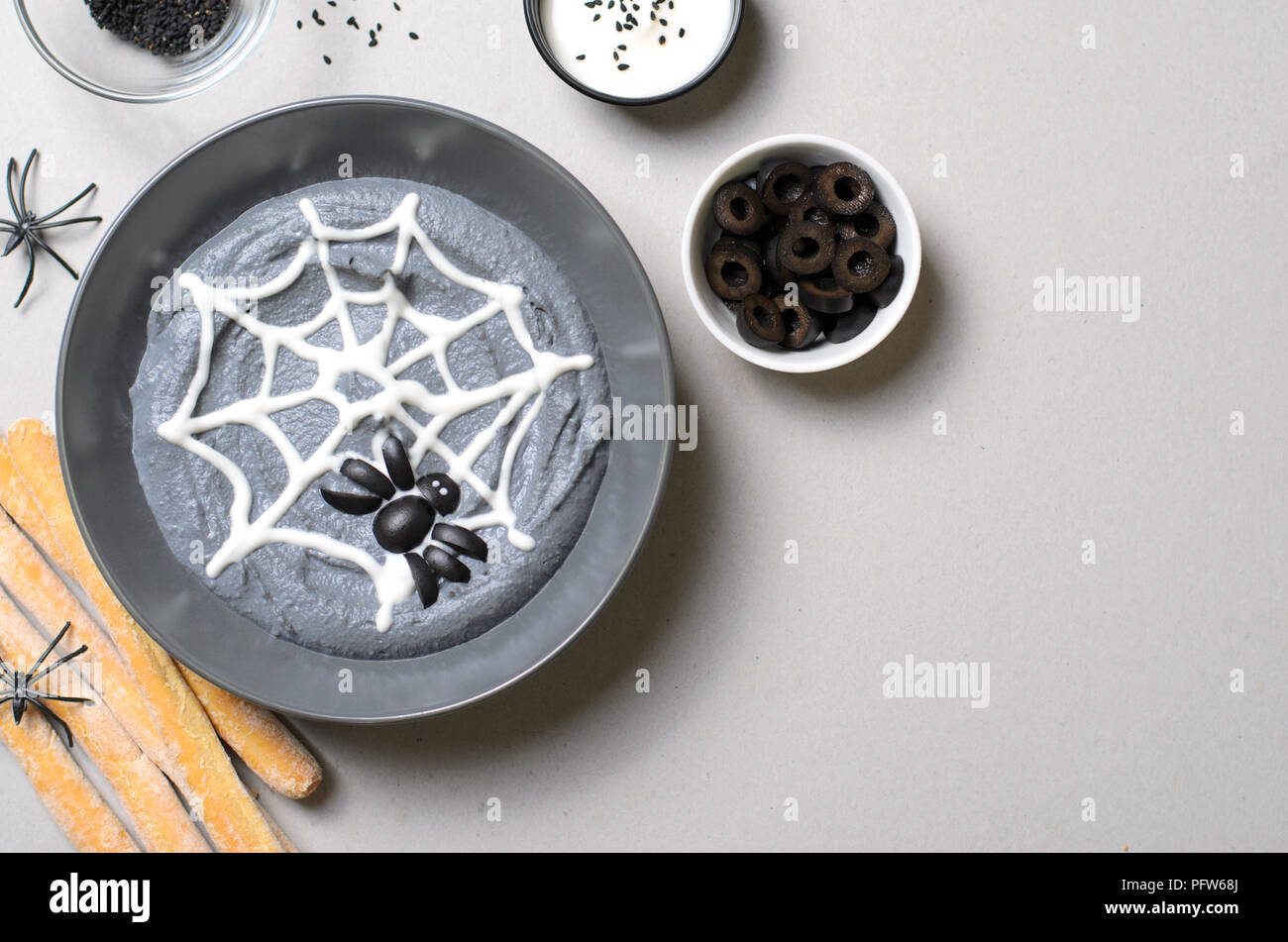 Black Hummus Halloween Dip Decorated with Cobweb and Spider, Halloween