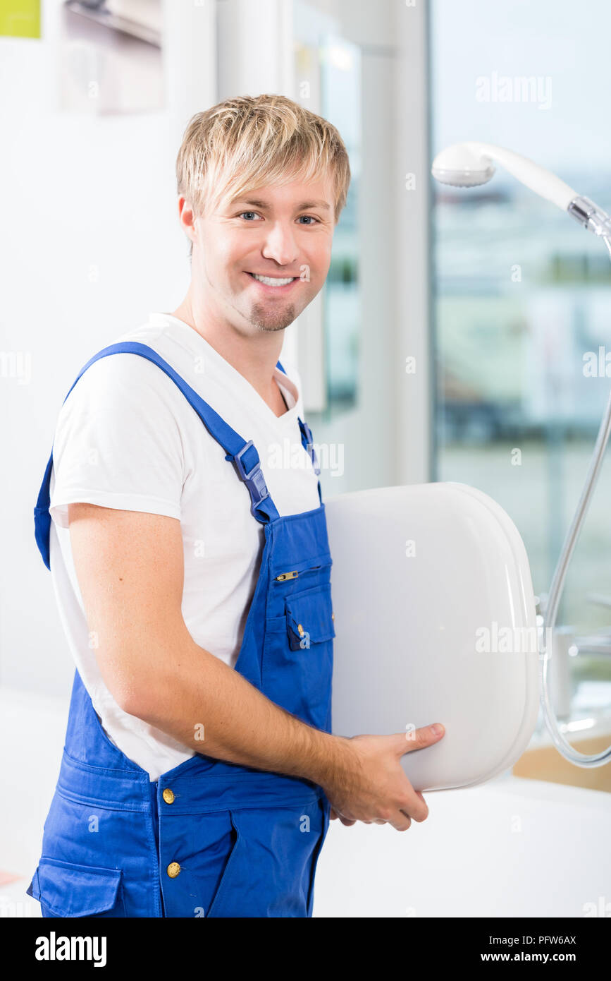 Portrait of a cheerful man working in a sanitary ware shop Stock Photo