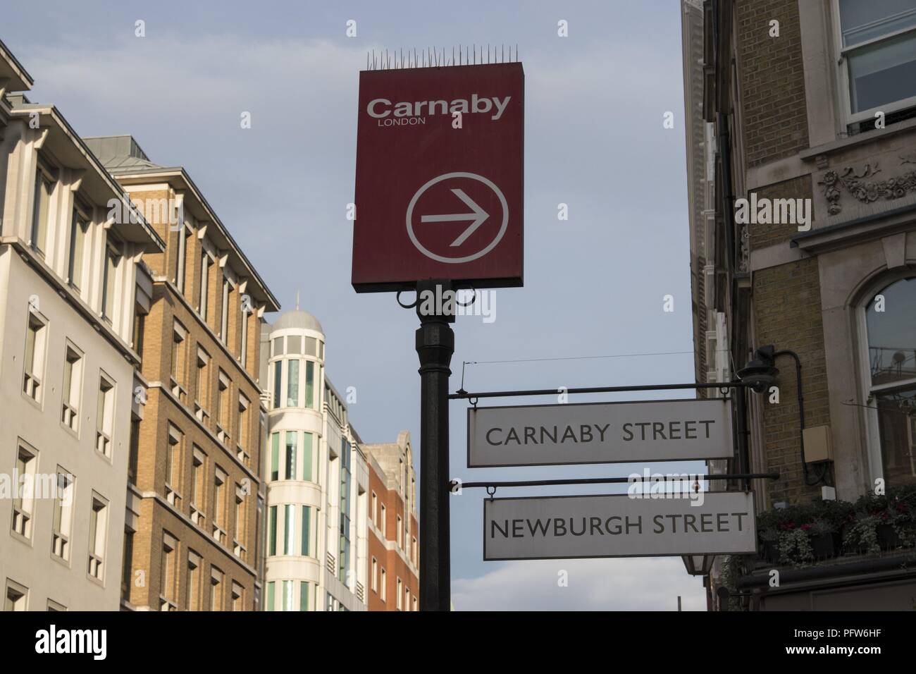 Street Sign between buildings, showing Carnaby Street and Newburgh Street, London, England, October 28, 2017. () Stock Photo