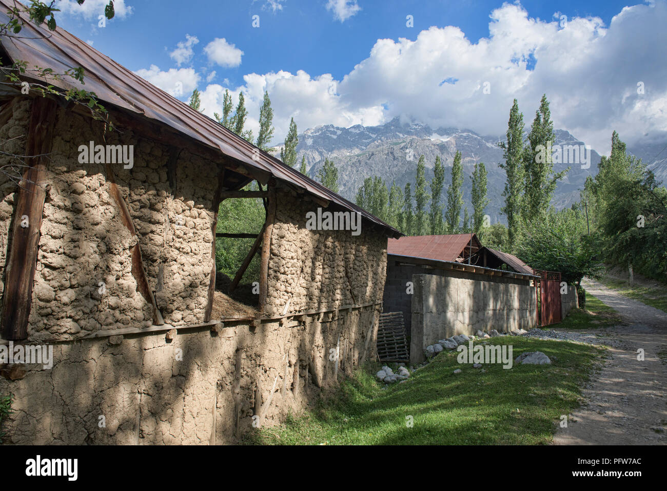Traditional farm and high peaks above the walnut village of Arslanbob, Kygyzstan Stock Photo