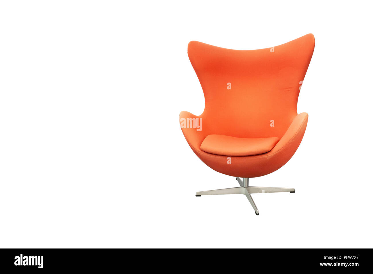 Orange fabric swivel armchair on metal stand in modern curve design for living room with leaning area of head isolated on white background. Stock Photo