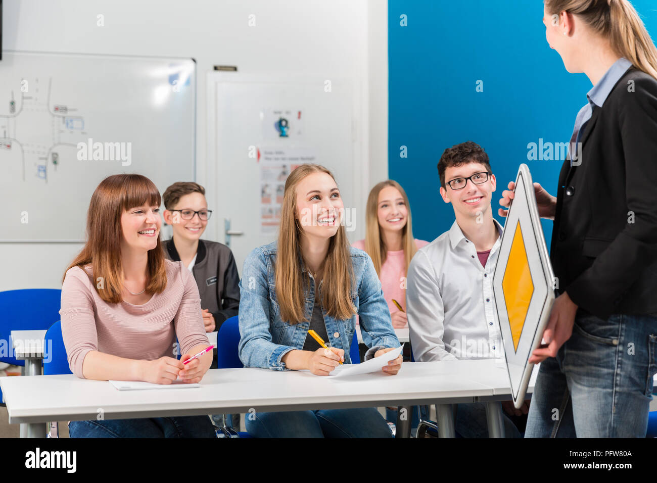 Students listing to their teacher in driving class Stock Photo
