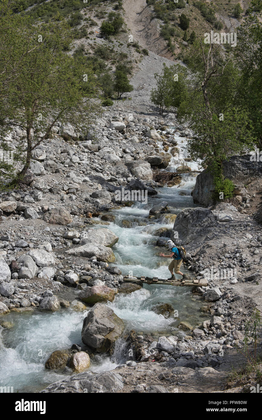 River crossing while trekking from the walnut village of Arslanbob, Kyrgyzstan Stock Photo