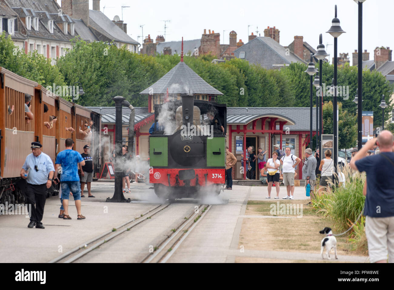 Tourists watch the steam locomotive at the seaside resort of Saint valery-sur-Somme Stock Photo