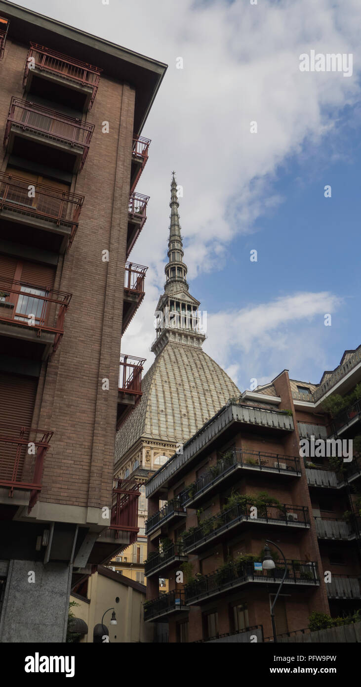 August 2018: Vertical view of the Mole Antonelliana between the buildings. The day is serene with some clouds to refresh. August 2018 in Turin Stock Photo