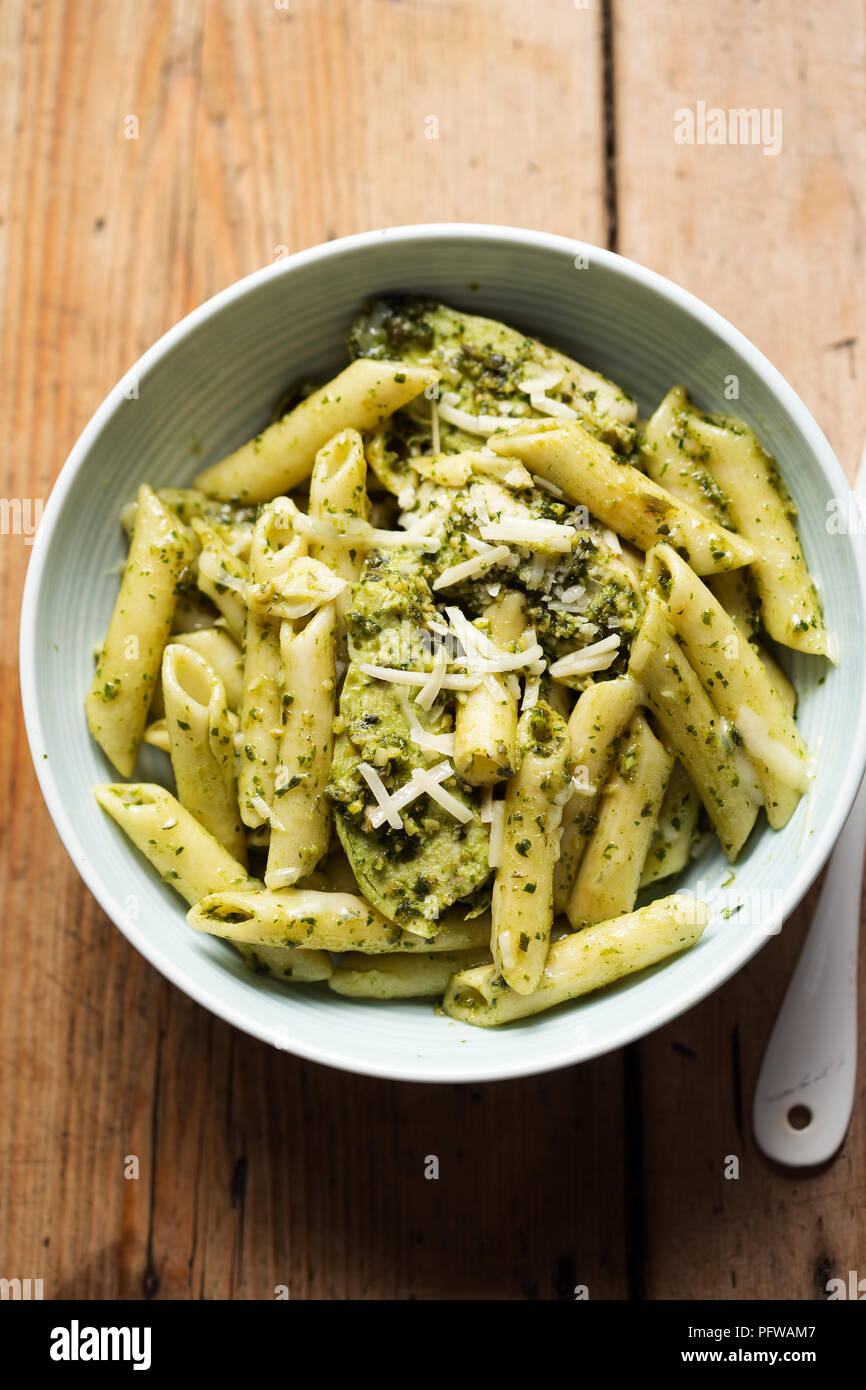 Green pesto chicken pasta with parmesan Stock Photo Alamy