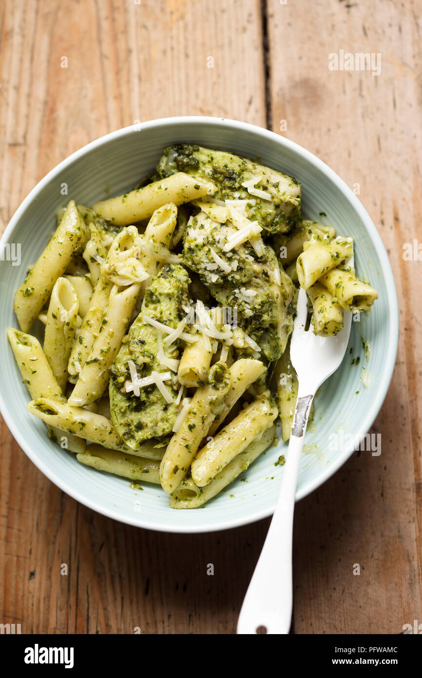 Green pesto chicken pasta with parmesan Stock Photo Alamy