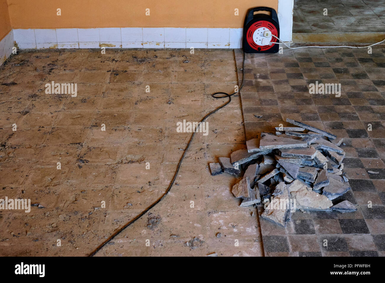 removal of original floor tiles in an old farmhouse due to damp rising up through floor from below zala county hungary Stock Photo