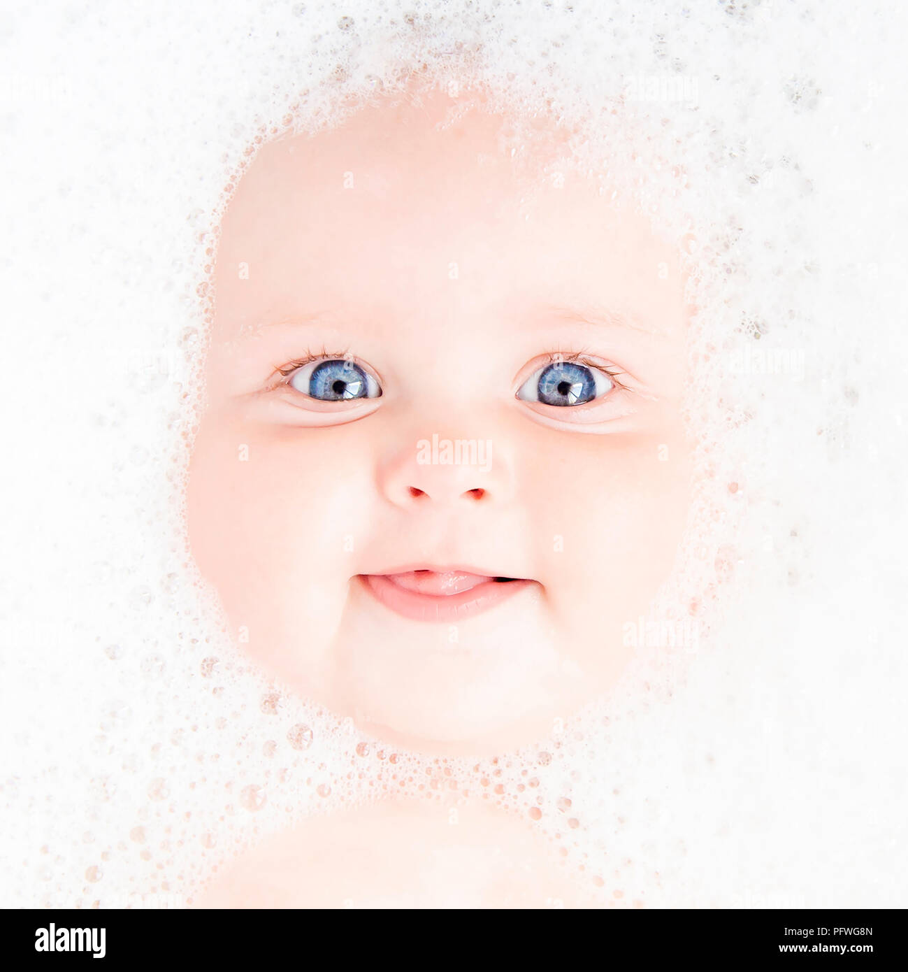 Baby's portrait - surrounded by bubbles in a bath Stock Photo