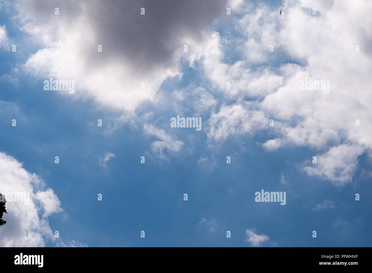 timelapse of moving clouds going from a bright sky to a dark sky Stock Photo