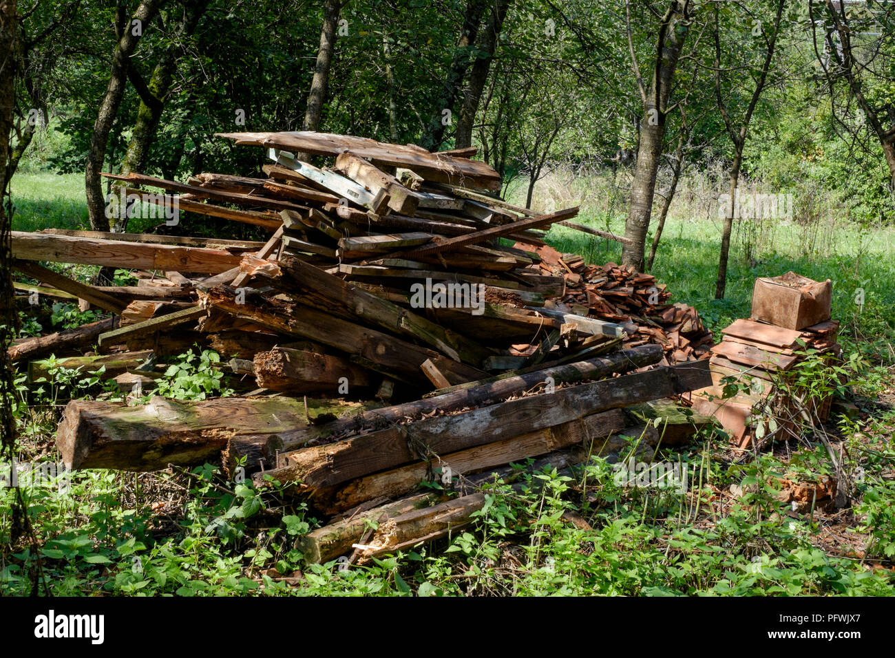pile of rotting wood stacked after removal from a derelict building zala county hungary Stock Photo