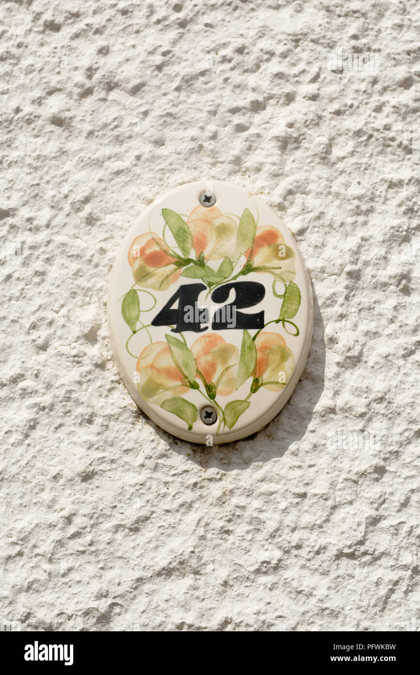 House number 42 sign on ceramic tile with painted flowers Stock Photo