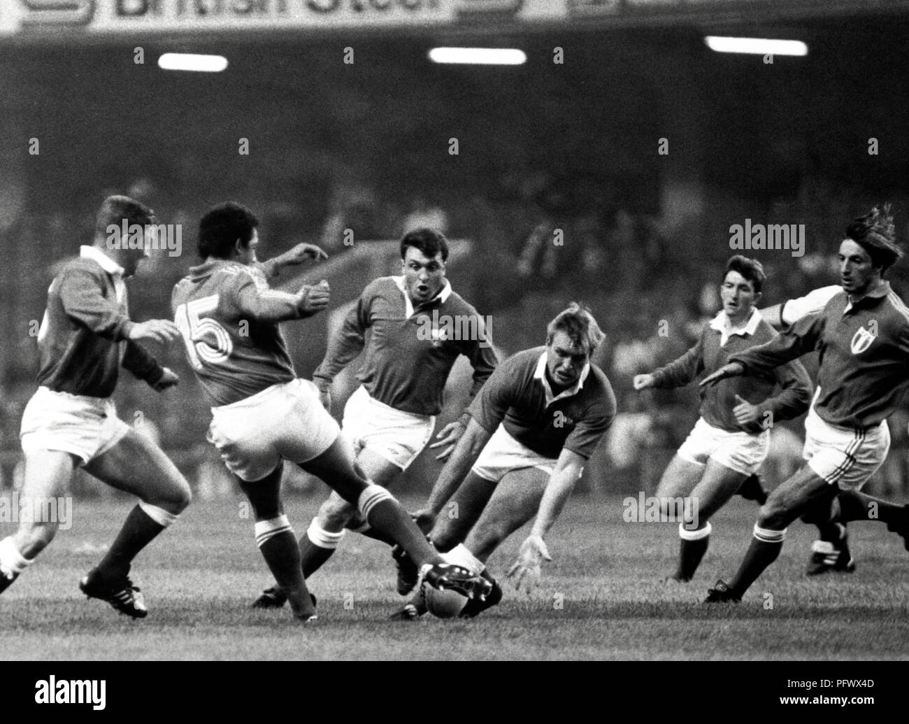 Wales 9 v France 22 in Cardiff. Mike Hall prepares to gather Serge Blanco's (15) fly kick Stock Photo