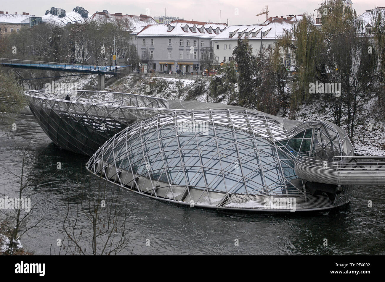 Another modern design sits in the middle of the fast flowing River Mur. It is a cafe, amphitheatre and a playground.  The Murinal resembles a giant mu Stock Photo