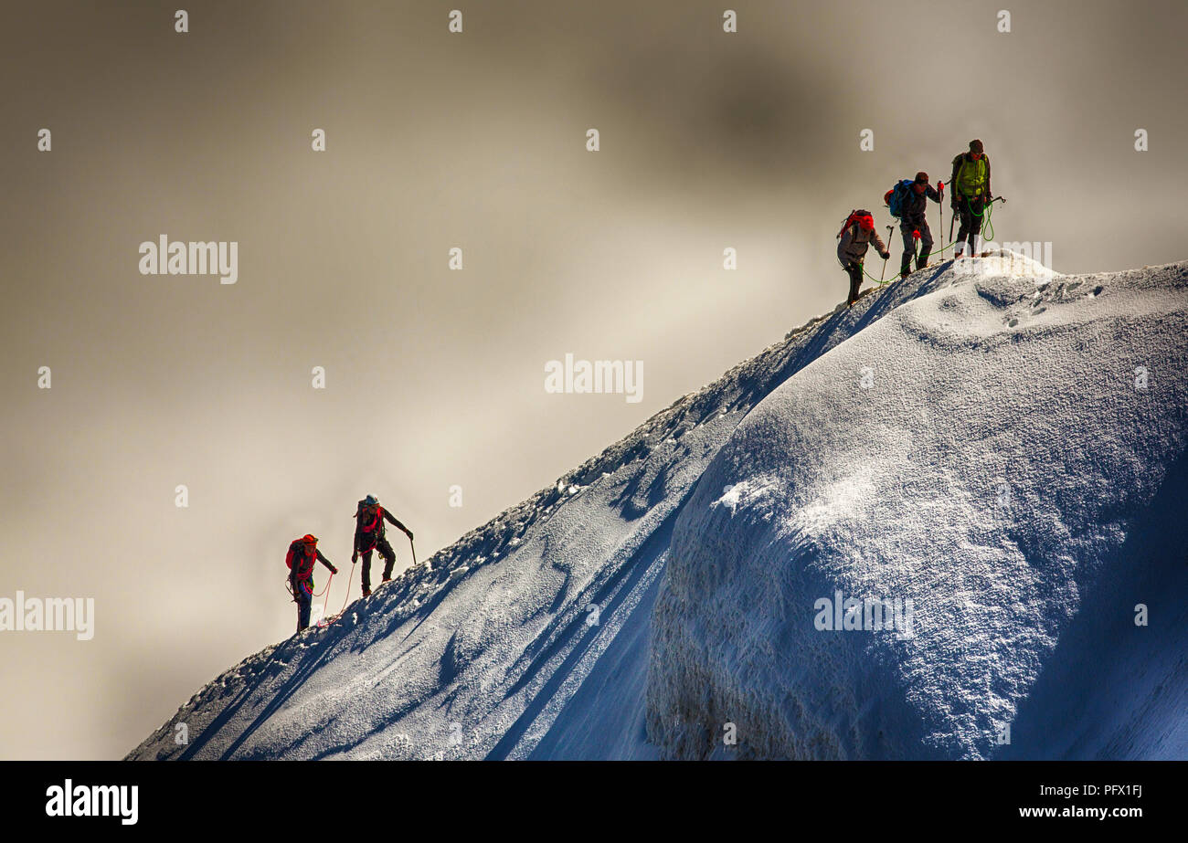 Climbers on the arete leading up from the Vallee Blanche to the Aiguille Du Midi above Chamonix, France. Stock Photo