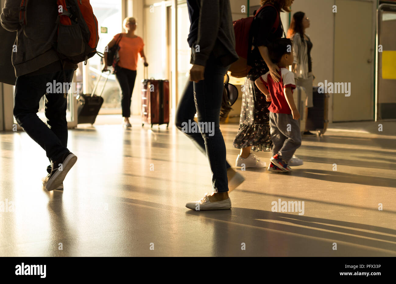 Group of pasenger walking in the airport pulling suitcase  Stock Photo