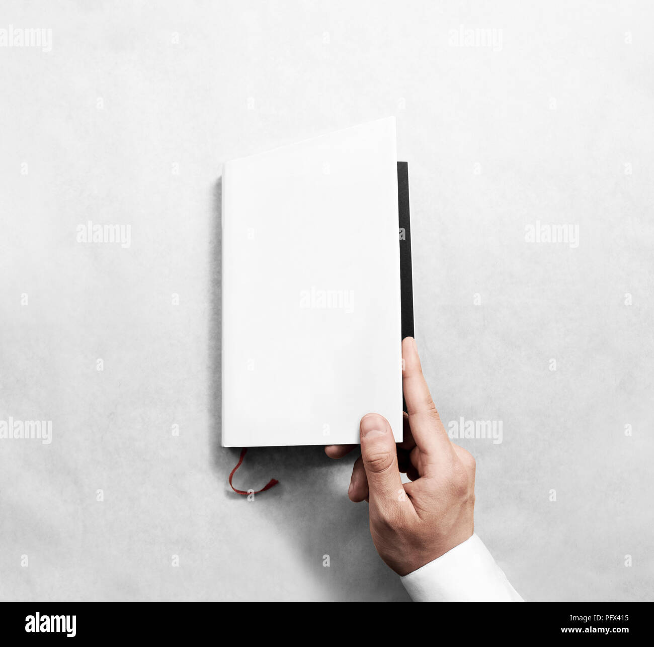 Hand opening blank white book cover mockup template. Clear booklet front surface design mock up. Arm holding opened textbook diary. Reading clean note Stock Photo