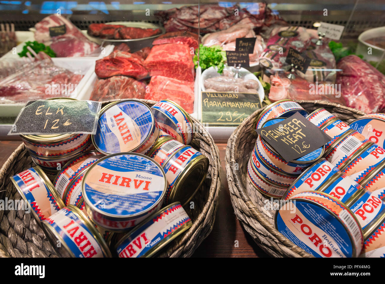 Finland food, tins of moose and reindeer meat for sale at a butcher's stall in the Kauppahalli market hall in the harbor area of Helsinki, Finland. Stock Photo