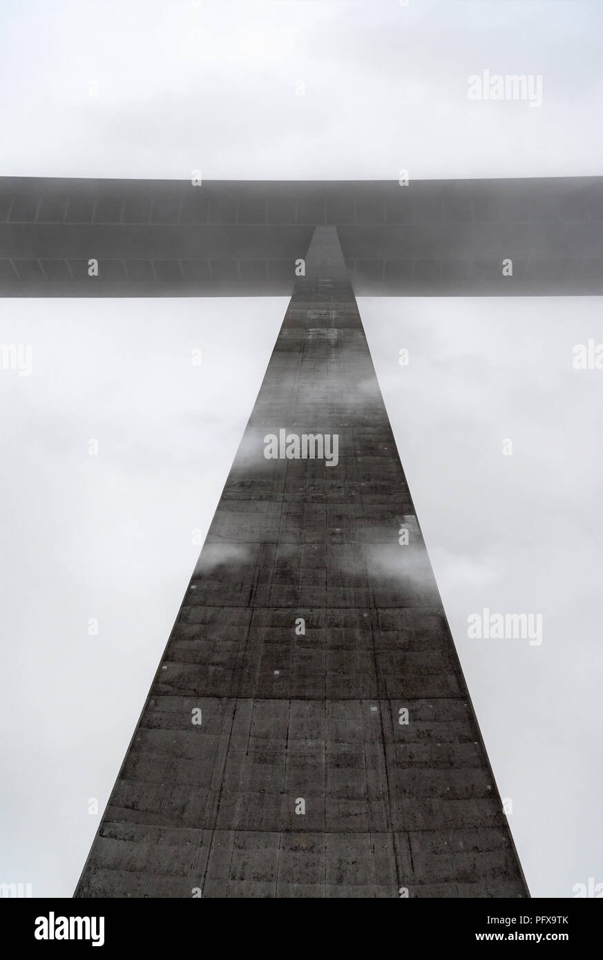 Detailed image of a pillar from the highest bridge in Germany, viewed from beneath, piercing the fog and the clouds, near Schwabisch Hall, Germany. Stock Photo