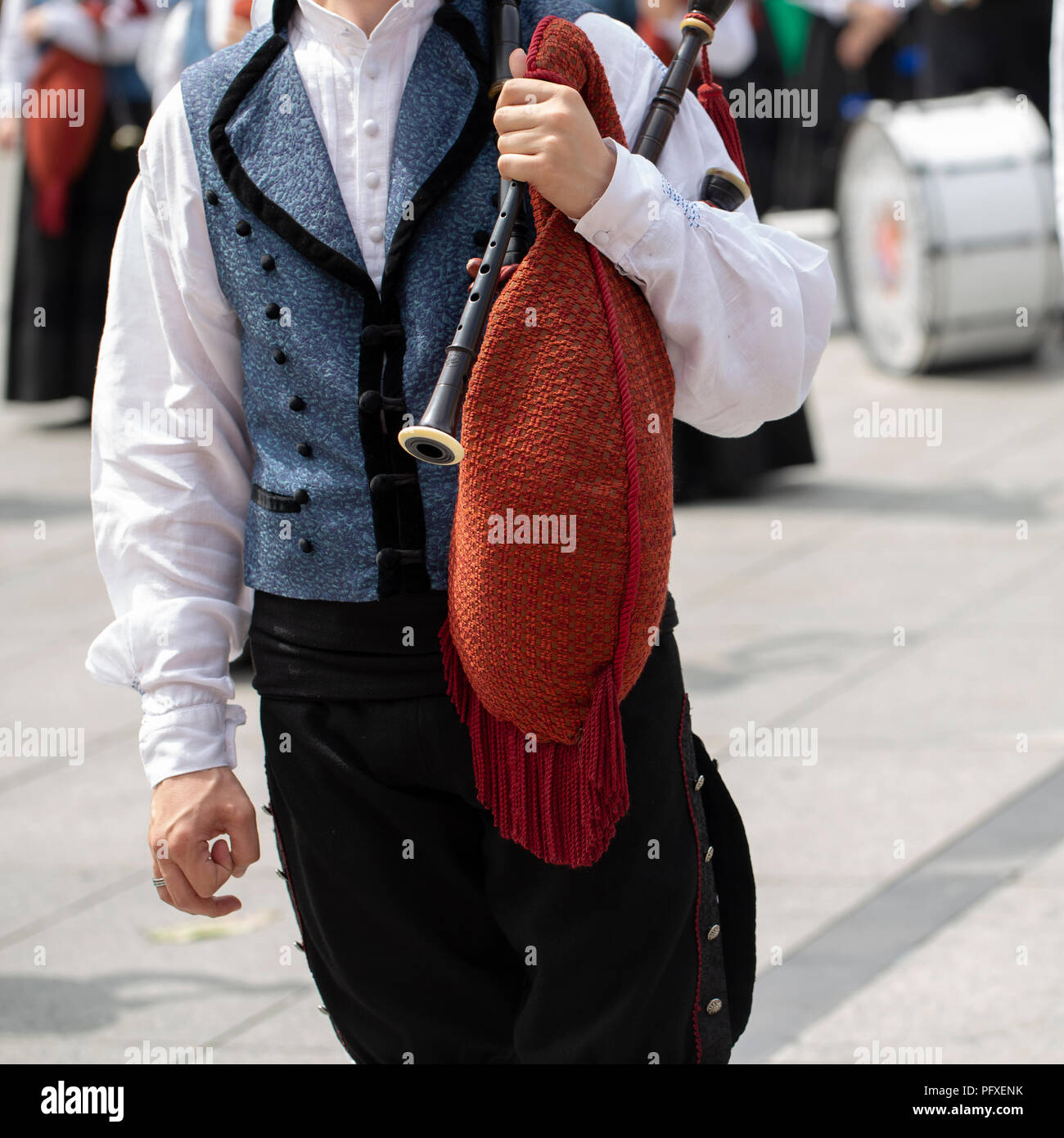 Man is holding a bagpipe, spanish traditional dance group Stock Photo