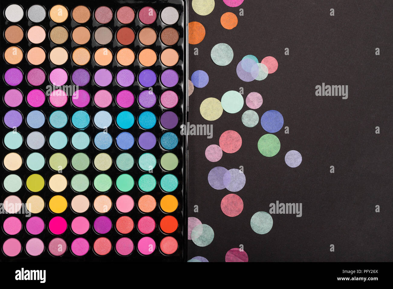 Closeup of makeup eyeshadow palette with confetti on black Stock Photo