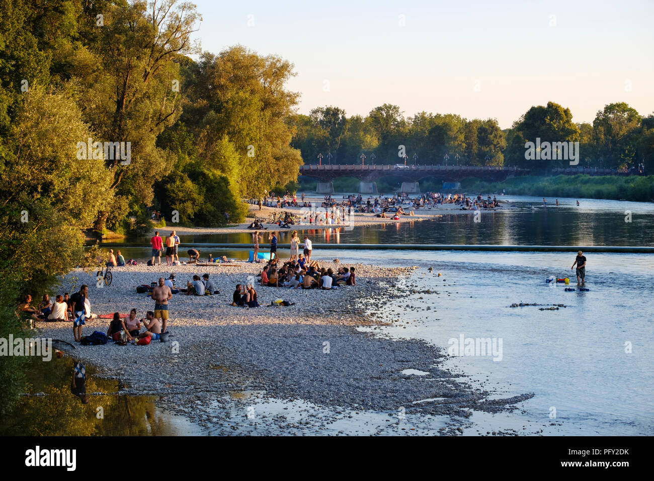 Teenagers on gravel bank at the riverside, Isar at Flaucher, Thalkirchner bridge, Thalkirchen, Munich, Upper Bavaria, Bavaria Stock Photo