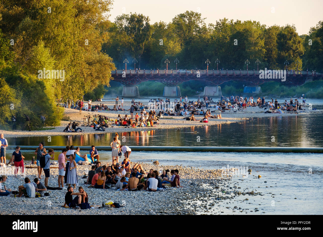 Teenagers on gravel bank at the riverside, Isar at Flaucher, Thalkirchner bridge, Thalkirchen, Munich, Upper Bavaria, Bavaria Stock Photo