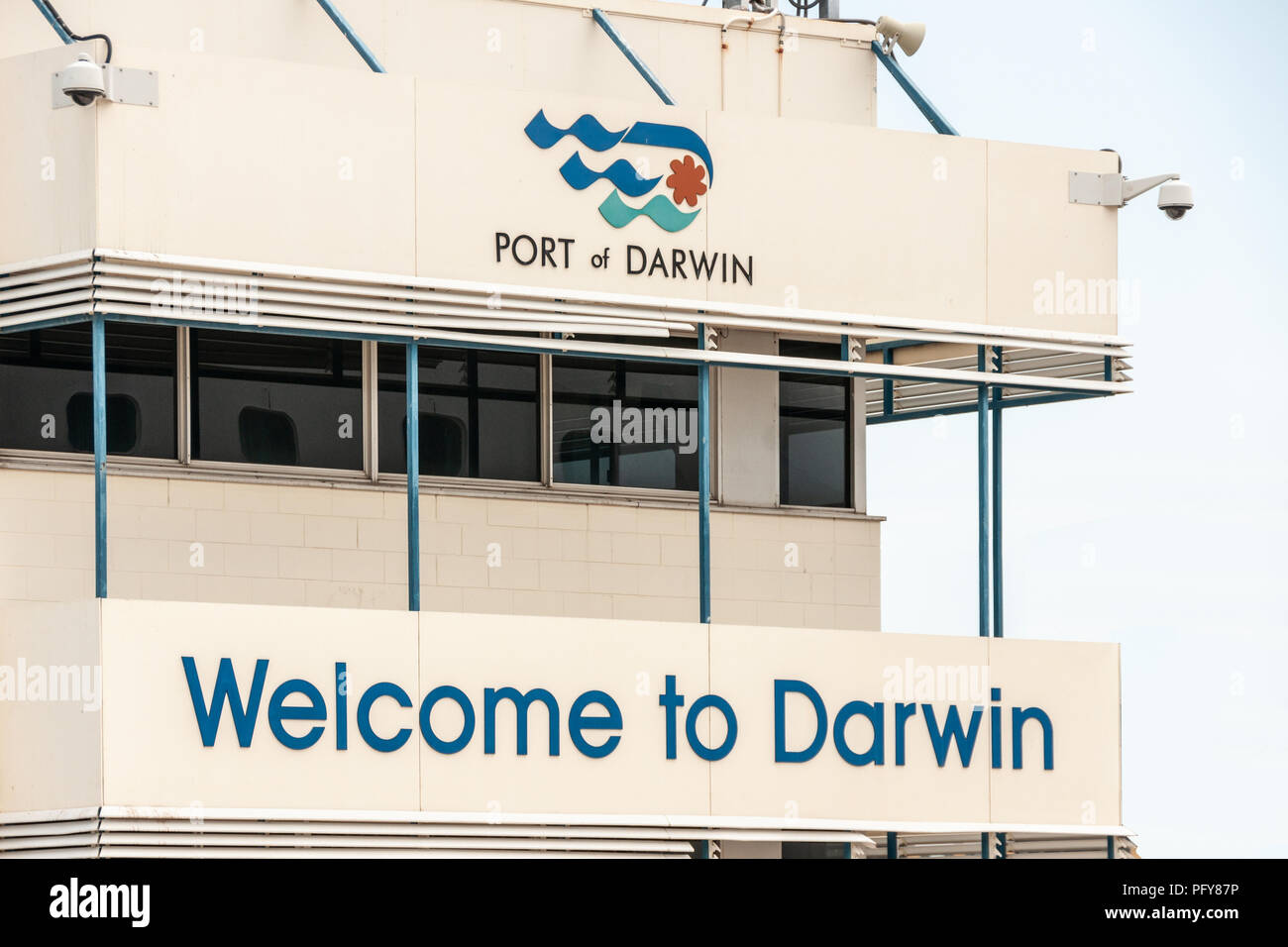 Darwin, Northen Territory, Australia - December 1, 2009: Welcome sign with logo to the Port of Darwin on white Terminal building. Gray sky. Stock Photo