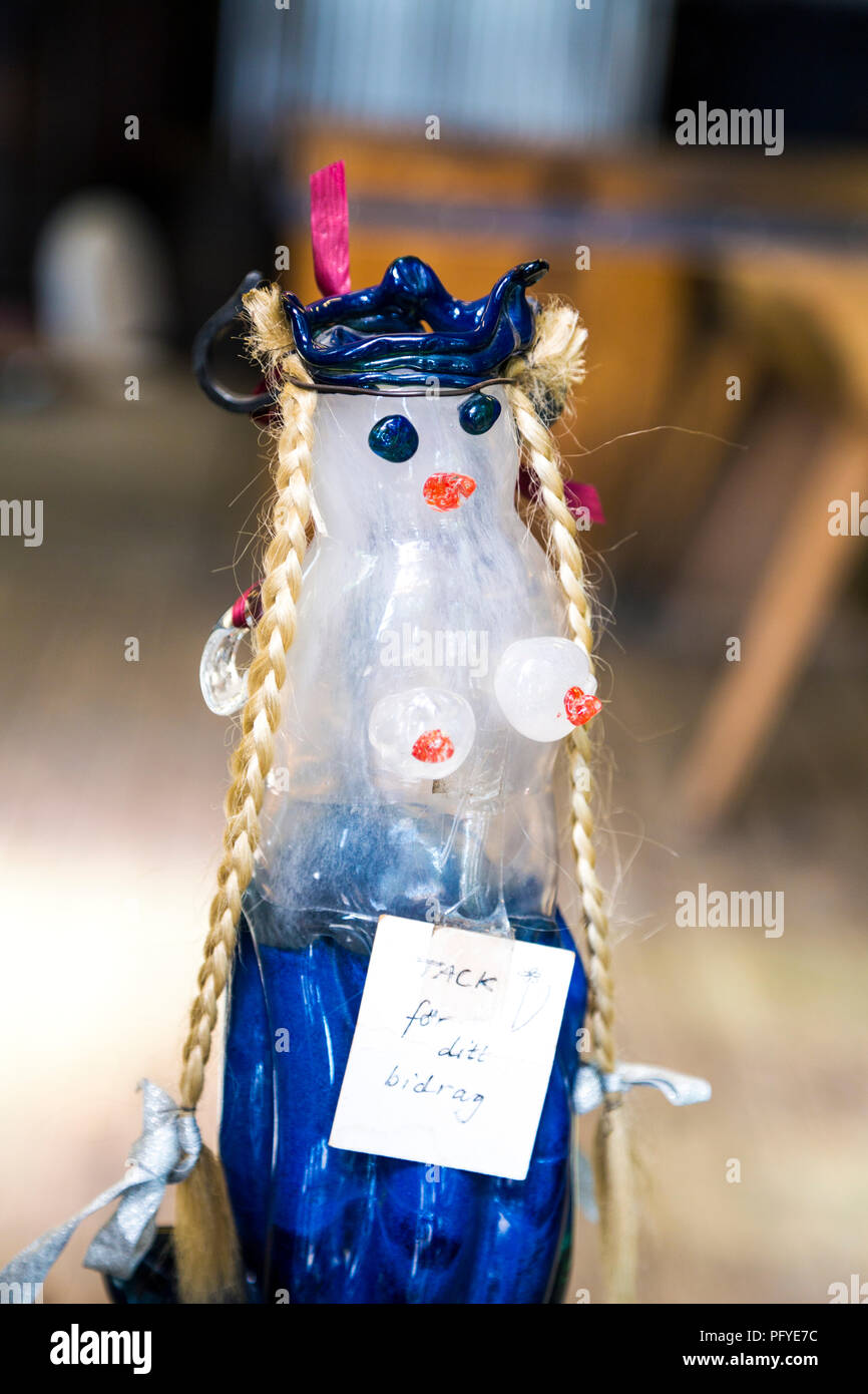 A naked viking woman with long braids at a glass blower's workshop in Fjaderholmarna, Stockholm