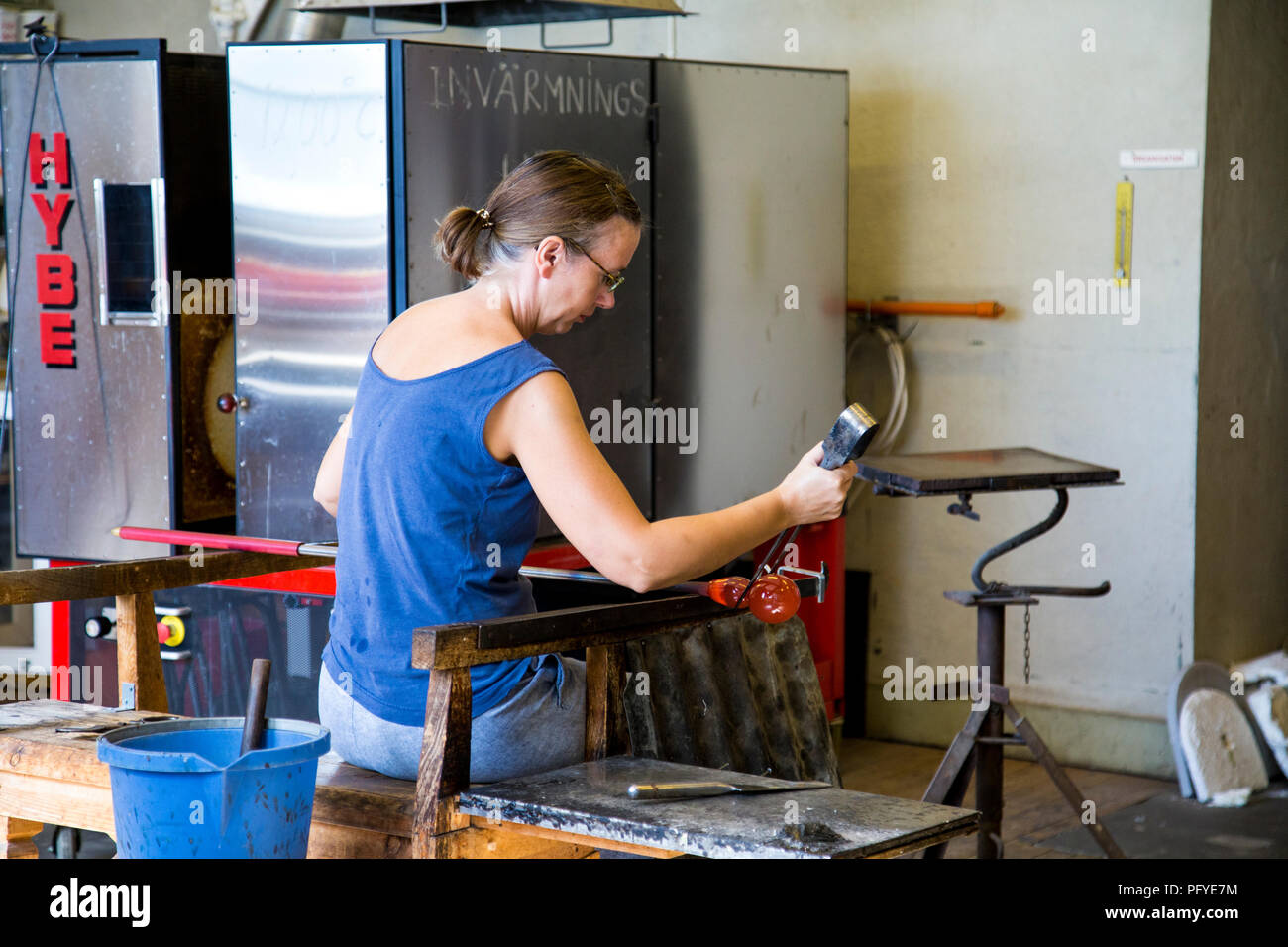 A woman blowing glass at a workshop in Fjaderholmarna, Stockholm archipelago, Sweden Stock Photo