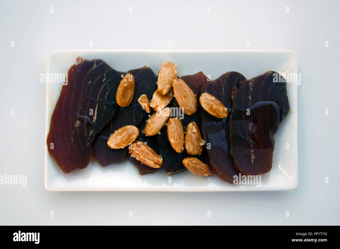 Cured brown tuna, almonds and olive oil, Spain Stock Photo