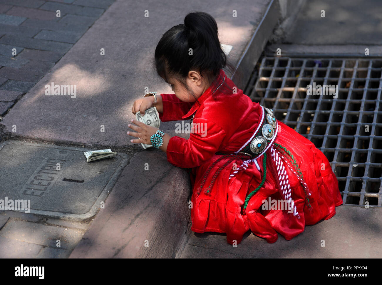 A young Navajo girl in traditional Navajo clothing and jewelry at the Santa Fe Indian Market Stock Photo